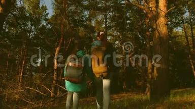 母女旅行者带着背包穿过<strong>树林</strong>。 在松林中的徒步旅行者。 <strong>游</strong>客喜欢